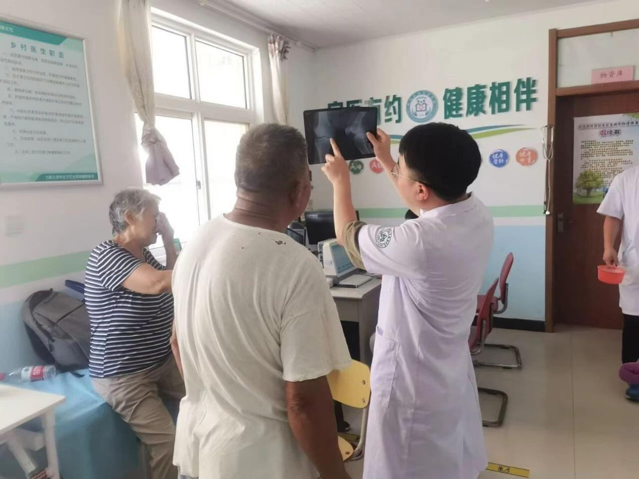 李春林耐心向老人解读骨骼影像。受访者供图